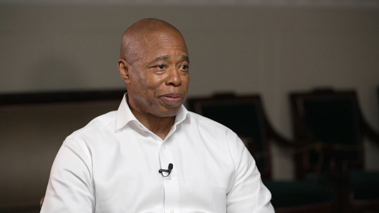 A portrait of a young Eric Adams in his police uniform.